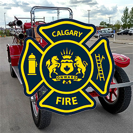 The Calgary Fire logo over a photo of an antique frietruck